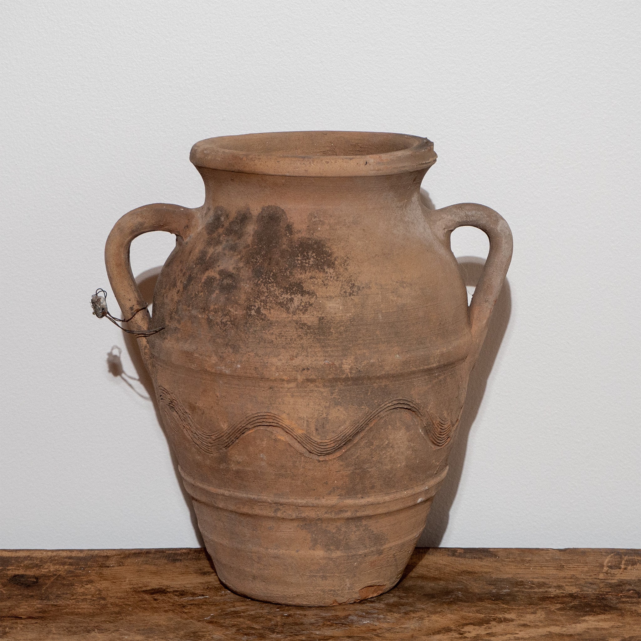 Vintage Turkish double handled jug urn on vintage wooden bench
