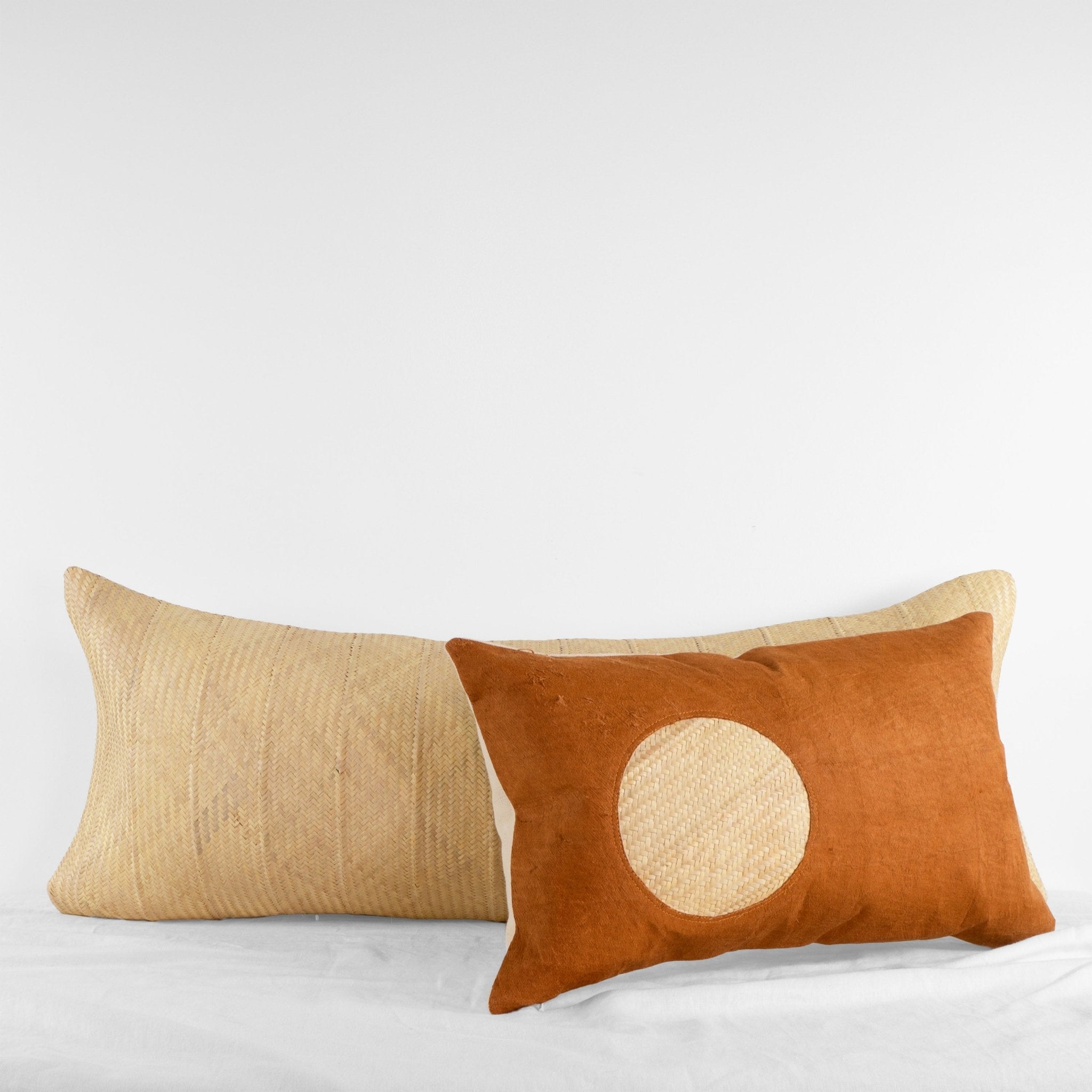 Handwoven natural palm leaf oversized lumbar cushion and barkcloth lumbar throw cushion from Uganda